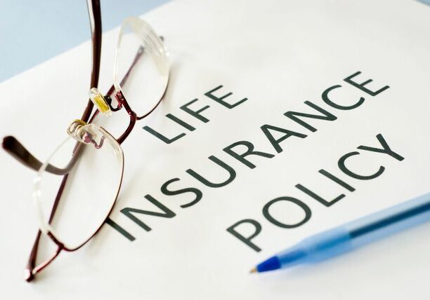 A life insurance policy is written on top of the paper.